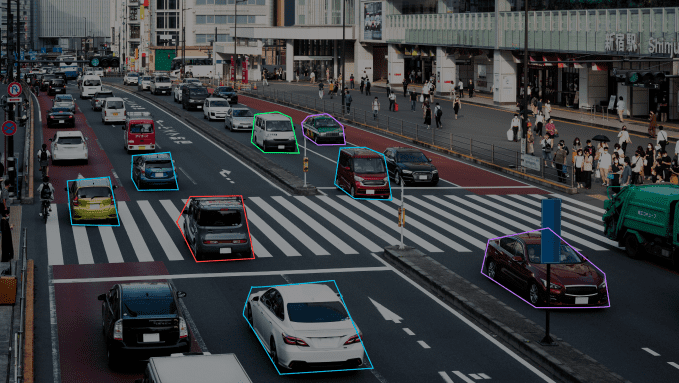 The image illustrates automotive object movement tracking with vehicles highlighted in multicolored shapes.
