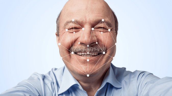 An elderly man passes through a facial recognition system, with a scanning overlay on his face.