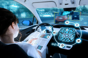 A young woman reading a book in anA young woman reading a book in an autonomous car illustrates the concept of training data for self-driving vehicles. autonomous car.